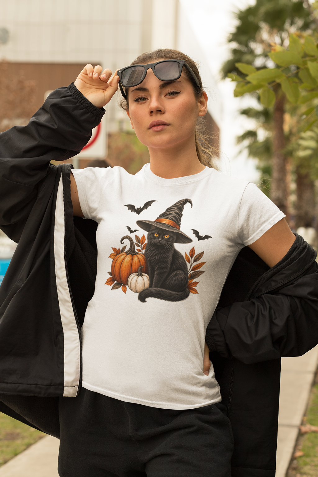 Halloween T-shirt, featuring a black cat, wearing a witches hat with bats and pumpkins